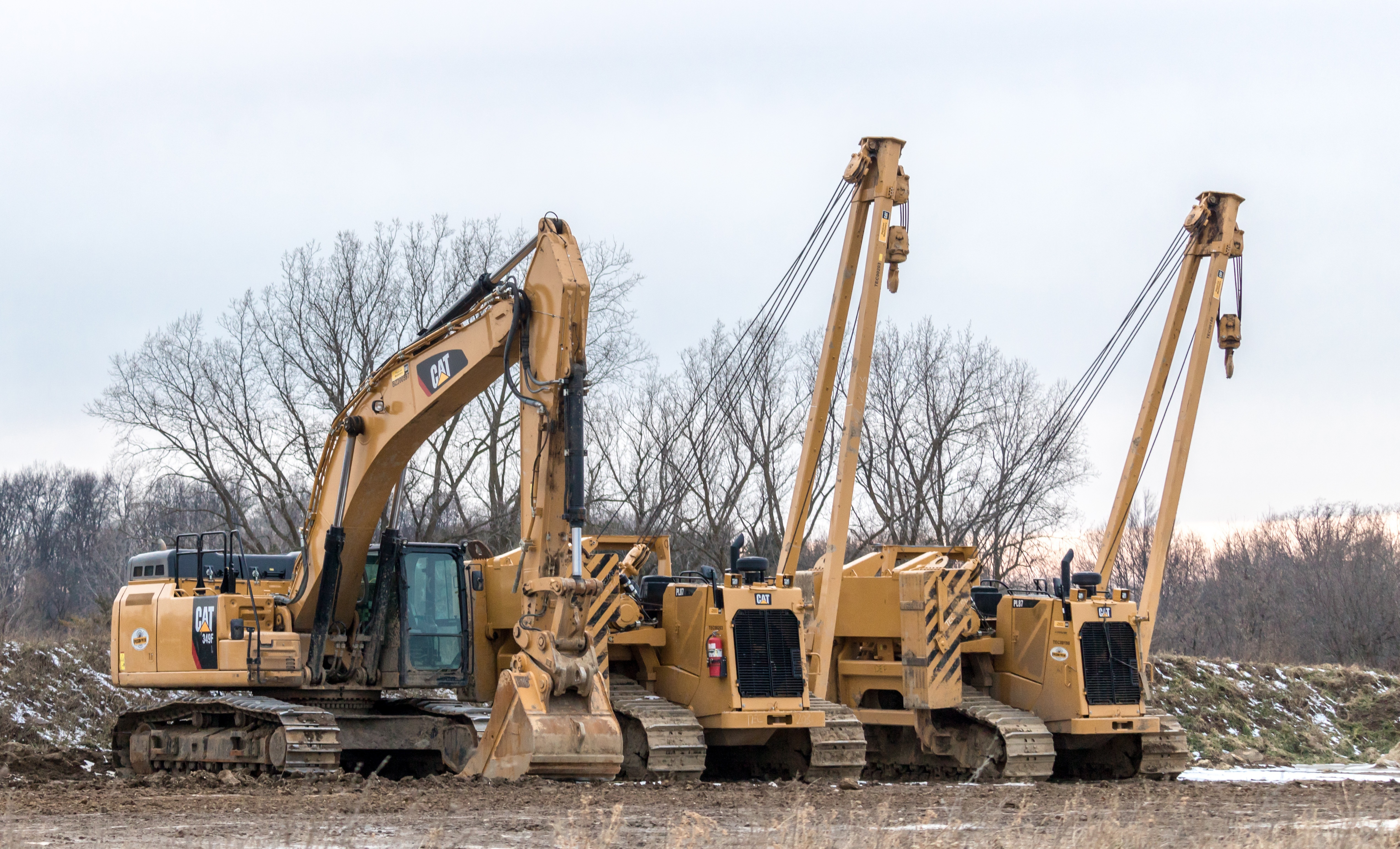 heavy equipment lot with machines in a row